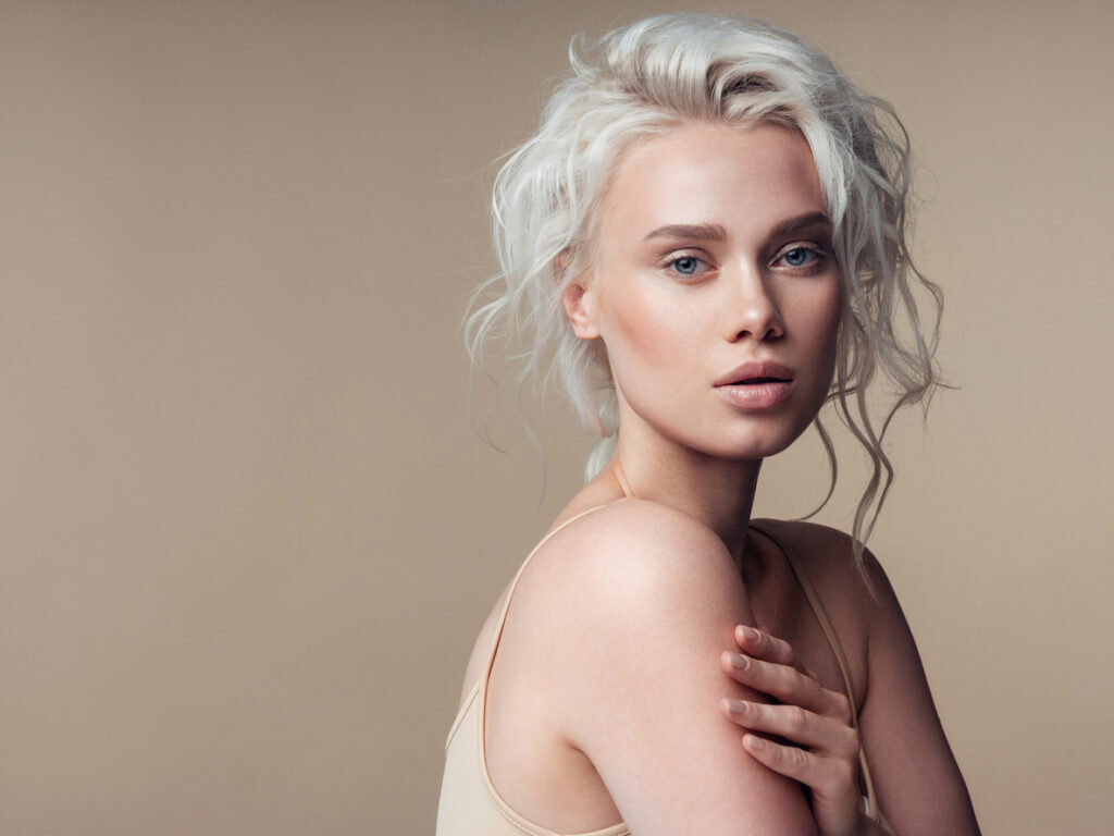 Woman with styled hair and smooth skin for Xeomin treatment content