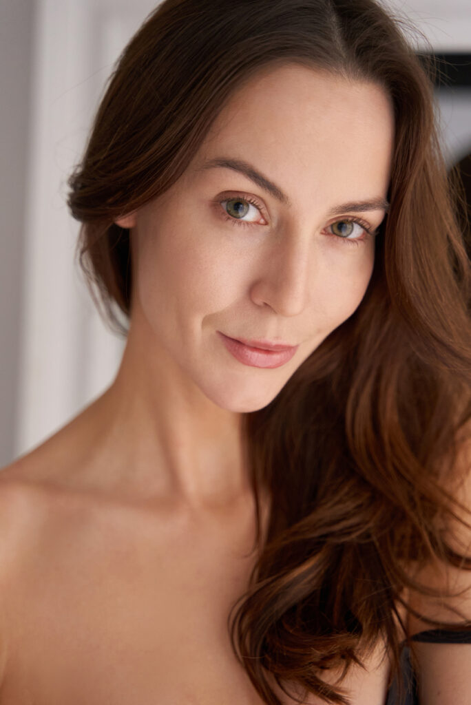 Woman with smooth skin looking at camera for Sculptra treatment content