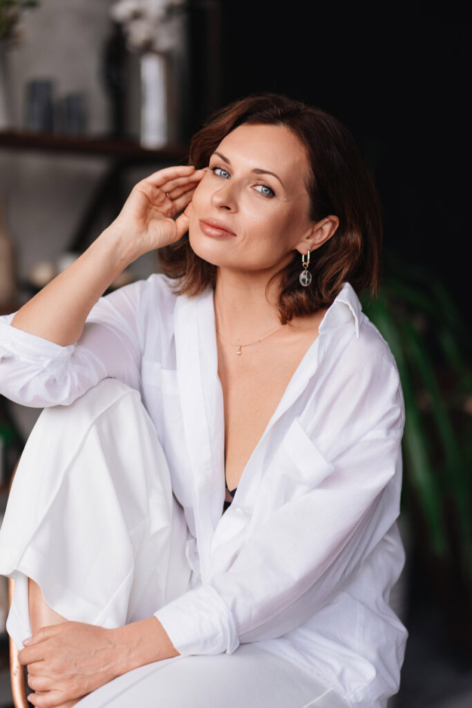 Woman applying skincare for Xeomin and facial aesthetics content