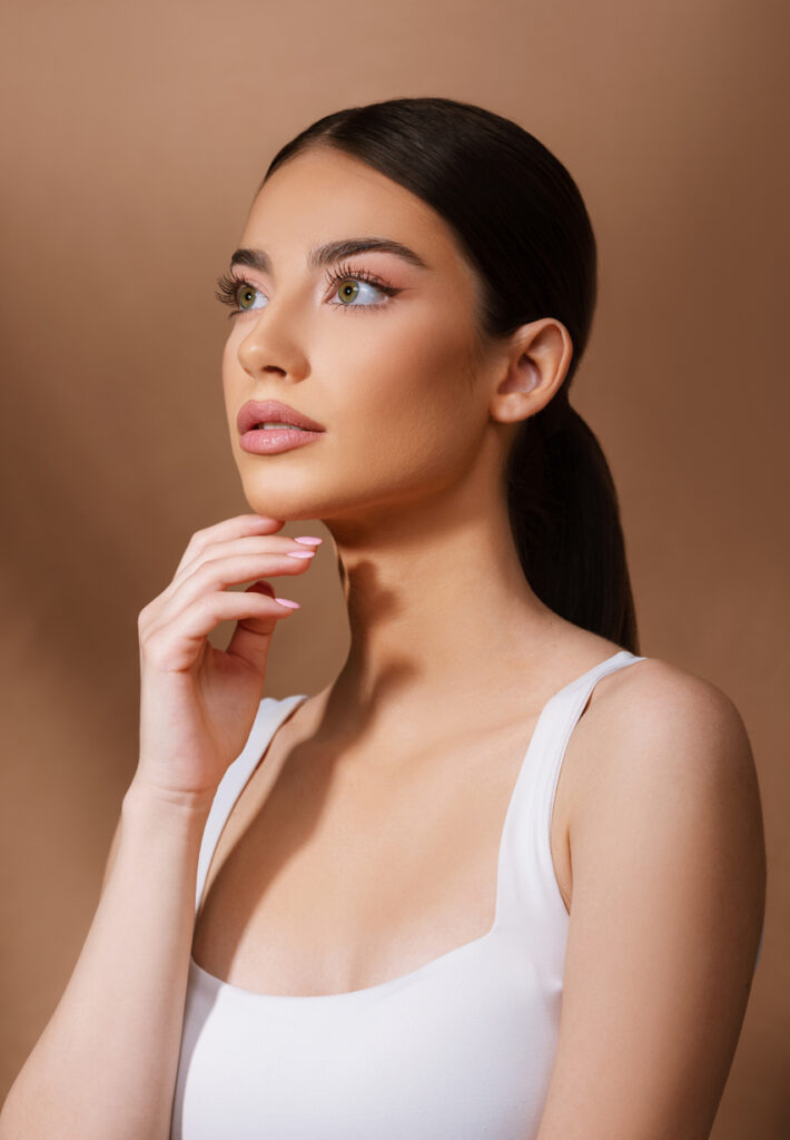 Woman touching her chin with smooth skin for Xeomin content