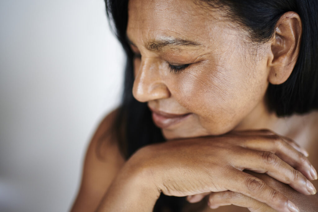 Mature woman with eyes closed for wellness and hormone therapy content
