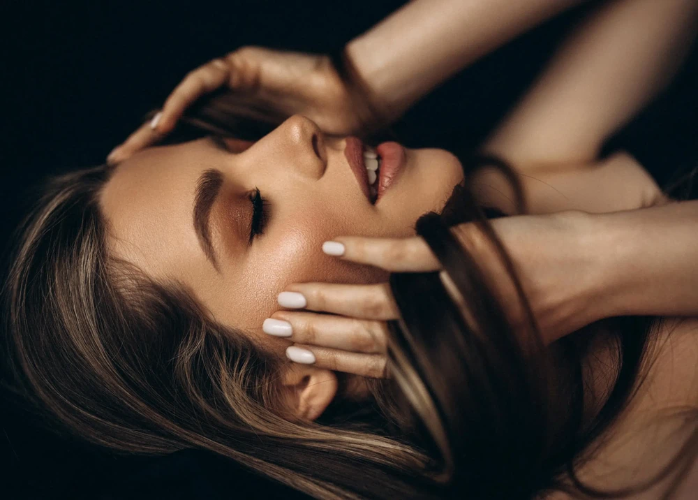Close-up of a woman with smooth, glowing skin, illustrating the healthy results achievable with proper microneedling aftercare.